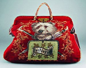 A Berlin woolwork embroidered and beadworked ladies: A Berlin woolwork embroidered and beadworked ladies travelling bag circa 1850, worked to one side with a beadworked King Charles Spaniel and to the other with a Highland terrier and the word `Bon