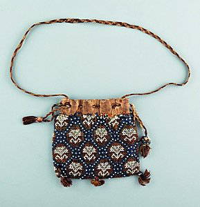 A beadworked bag, English, circa 1630, worked with: A beadworked bag, English, circa 1630, worked with white and clear carnation sprigs within golden beaded lozenges and a blue lattice, lined in white leather, plaited cord drawstring, 12cm, 3 3/4in