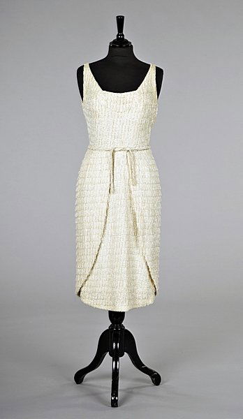 A fine Jean Dessès beaded and sequined cocktail dre: A fine Jean Dessès beaded and sequined cocktail dress, early 1960s, the taffeta inner-corset labelled and numbered 9649, with deep neckline, tulip shaped skirt with one panel fastening to the left hi