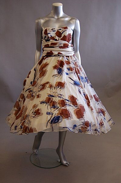 An Antony Price fifties-inspired printed chiffon go: An Antony Price fifties-inspired printed chiffon gown, 1990s, the fabric designed by Cecil Beaton, with boned, strapless bodice, the full skirt with hooped petticoat, cummerbund sash to the waist, bus