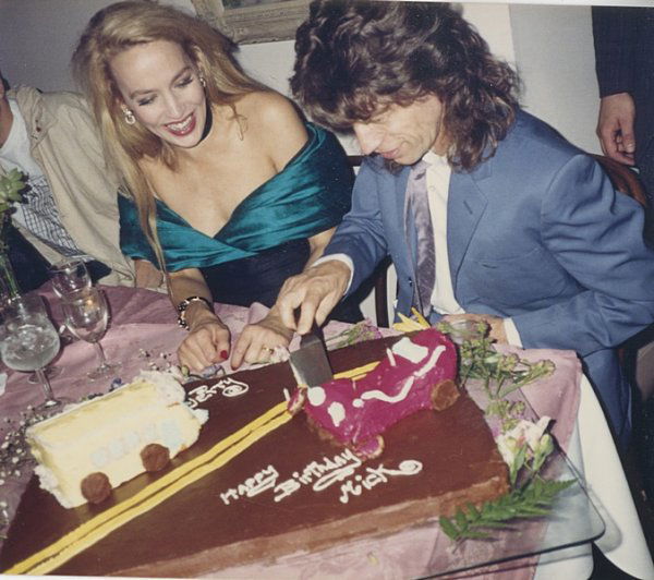 Four Antony Price ensembles, 1980s-90s, labelled,: Four Antony Price ensembles, 1980s-90s, labelled, comprising cream brocatelle cocktail suit, the double breasted jacket with peplum and full sleeves; a slubbed blue/green silk suit with bow-shaped hem