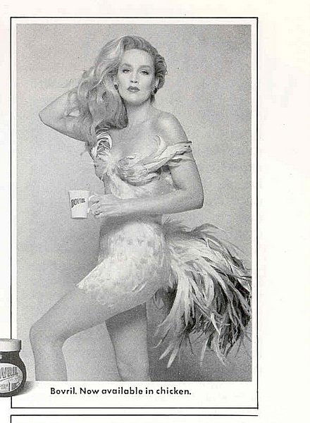 The Antony Price `chicken' dress worn by Jerry Hal: The Antony Price `chicken' dress worn by Jerry Hall to attend a party given by Princess Margaret and also in a Bovril advertisement, 1990s, labelled, the short dress of yellow and green plumes with ad