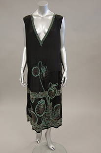 A 'House of Adair of France' beaded crepe cocktail: A 'House of Adair of France' beaded crepe cocktail dress, early 1920s, labelled for Paris, London and Montreal, adorned with jade green, silver and crystal beads, bust 102cm, 40in