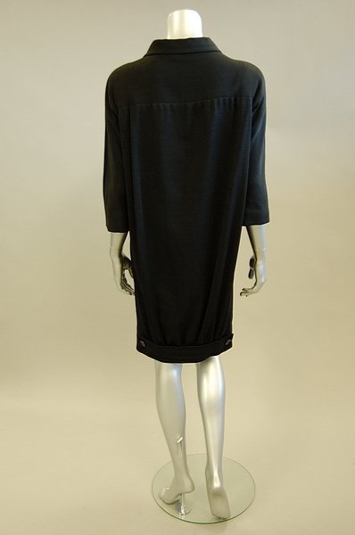 A Balenciaga black wool jersey coat, Summer, 1958,: A Balenciaga black wool jersey coat, Summer, 1958, labelled and numbered indistinctly, cut loose and straight at the front but with the rear hem gathered into a button-ended band, chest 122cm, 48in Pr