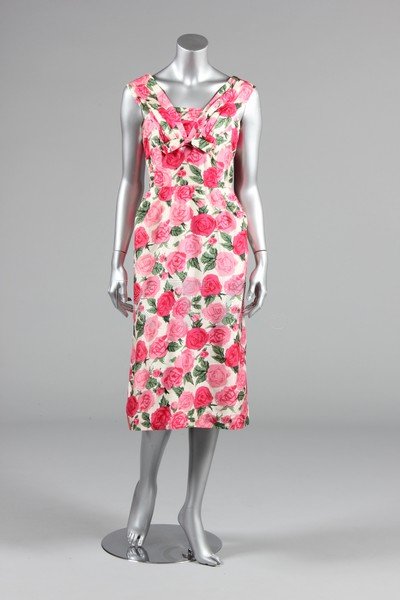 A figure-hugging rose printed silk dress, late 1950s,: A figure-hugging rose printed silk dress, late 1950s, bust 86cm, 34in, waist 56cm, 22in; together with a Harvey Berin by Karen Stark black cutwork over pink rayon cocktail dress; a fuchsia slubbed sil