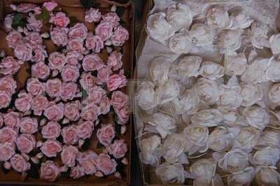 Six boxes of bridal silk flowers, comprising: one of: Six boxes of bridal silk flowers, comprising: one of silver grey and dusky pink floral sprays (135); one of lemon yellow roses (35); one of small pink roses (60); one of white roses (40); one of small