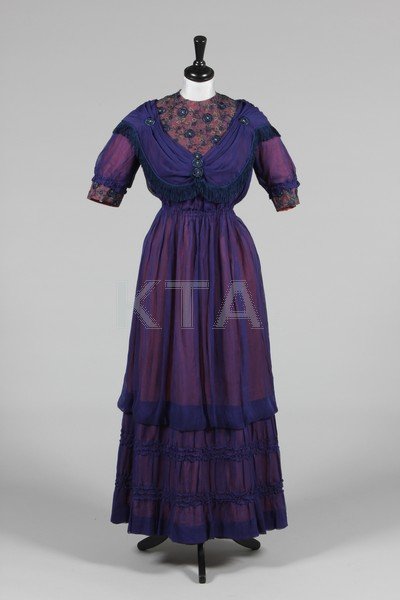 A royal blue muslin evening gown circa 1918, with: A royal blue muslin evening gown circa 1918, with old-rose cotton lining, the bodice inset with embroidered Edwardian lace, trimmed with fringes, bust 86cm, 34in; together with a striped satin, gauze 
