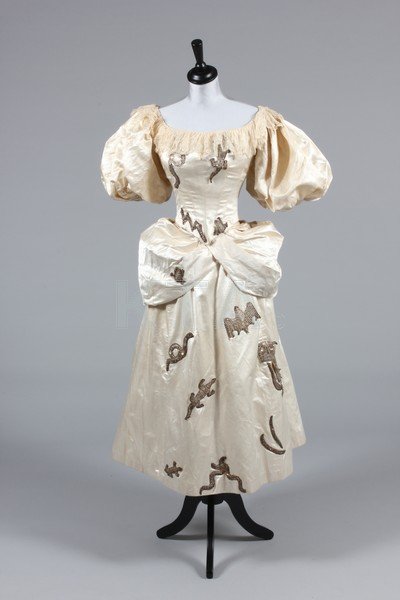 A 'White Witch' fancy dress ensemble, circa 1885,: A 'White Witch' fancy dress ensemble, circa 1885, labelled 'Miss Shannon Costumier, Sligo', the ivory satin dress applied with high relief sequined silver motifs including an owl, bat, lizards, snakes