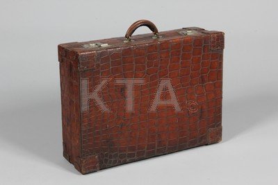 A crocodile suitcase, 1930s, 61cm long; together with a: A crocodile suitcase, 1930s, 61cm long; together with a lacquered card and leather trunk, a top hat in leather case; and a folding silk opera hat (qty)