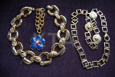 A Gianni Versace gilt medusa head belt, signed, approx: A Gianni Versace gilt medusa head belt, signed, approx 81cm, 32in waist, in box; together with a Escada daisy pendant bracelet, signed, in box and a Ciner chunky gilt link necklace (3)