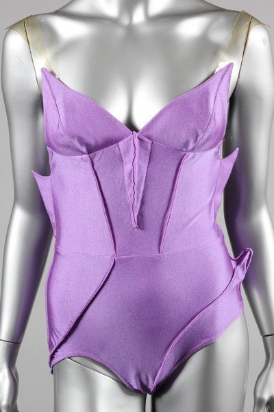 A Thierry Mugler purple polyamide jersey bodysuit or: A Thierry Mugler purple polyamide jersey bodysuit or swimsuit, Spring-Summer 1989, unlabelled, with clear vinyl straps, shark fins effect seaming, bust approx 81cm, 32in Literature: Spring-Summer '89 