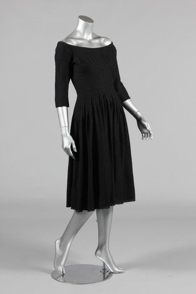 A Jacques Heim black boucle wool dinner dress, mid: A Jacques Heim black boucle wool dinner dress, mid 1950s, with Jeune Filles label, with sculpted, panelled gores to midriff and waist, bust 86cm, 34in, waist 66cm, 26in