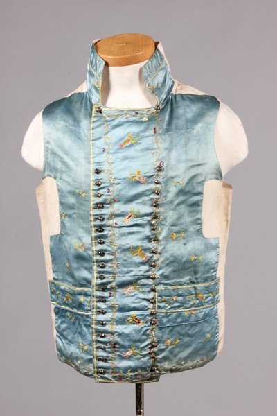 An embroidered blue satin waistcoat circa 1780-90,: An embroidered blue satin waistcoat circa 1780-90, worked in floss silks with rose-sprigs, double-breasted with two rows of facetted steel buttons, high stand collar and angular lapels