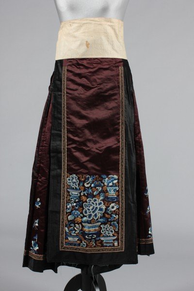 An embroidered skirt, Chinese circa 1900, of aubergine: An embroidered skirt, Chinese circa 1900, of aubergine satin embroidered in blue and white and with gold couching