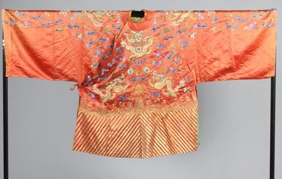 A copper-brown satin embroidered dragon robe, mangao,: A copper-brown satin embroidered dragon robe, mangao, Chinese, circa 1900, worked with eight large couched gilt thread dragons amid mainly blue and green floss silk clouds, carp and precious things, g