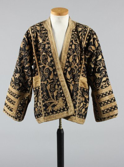 A lavishly embroidered black wool jacket, Ottoman, late: A lavishly embroidered black wool jacket, Ottoman, late 19th century, entirely covered in couched gold thread arabesques and blooms with gold braided cuffs and pocket details, lined in dark green felt