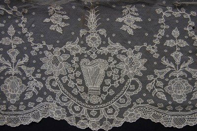 A Limerick needlerun dress flounce worked with harps: A Limerick needlerun dress flounce worked with harps and blooms c.1900, 31cm by 10m 50cm This flounce is photographed in 'Limerick Run Laces' by Pat Earnshaw, back cover and also pp 21-24. Provenance: