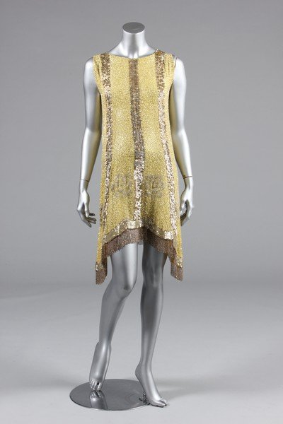 A beaded primrose-yellow muslin flapper dress: A beaded primrose-yellow muslin flapper dress, late 1920s, the ground covered with silver vermicular patterning, with seed-bead flowerheads, vertical gold and silver sequined stripes and gold beaded f