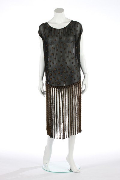 A beaded black chiffon flapper dress with 'ribbon': A beaded black chiffon flapper dress with 'ribbon' skirt, circa 1924, adorned with topaz-coloured seed bead roundels edged in black bugle beads, bust 112cm, 44in Gabrielle Chanel introduced a black fl