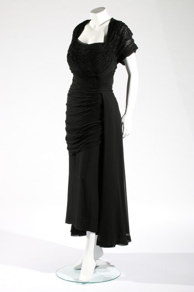 A Balenciaga couture pleated goffered chiffon and silk: A Balenciaga couture pleated goffered chiffon and silk crêpe dinner dress, probably Autumn-Winter, 1948, Paris labelled and numbered 41282, the bodice and draped skirt front horizontally pleated, wit