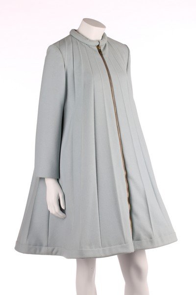 A Pierre Cardin pale blue wool coat-dress, 1967,: A Pierre Cardin pale blue wool coat-dress, 1967, labelled 'Pierre Cardin Paris 'collection' modeles exclusifs pour l'Allemagne', of sky-blue wool, the roll collar with prestud fasteners, large gilt zi