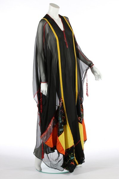 A Thea Porter chiffon kaftan, mid 1970s, couture: A Thea Porter chiffon kaftan, mid 1970s, couture labelled, piped and edged in scarlet satin, with yellow velvet ribbons down the front and back, the hem/sleeves inset with a patchwork of Chinese embro