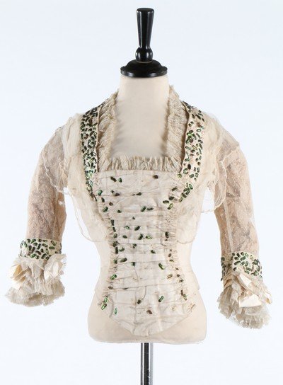 A group of mainly white or summery garments. including: A group of mainly white or summery garments. including an 1850s whiteworked muslin cape; two cotton/muslin dresses c.1914-18; beetle-wing adorned 1890s silk bodice, assorted blouses, bodices and under