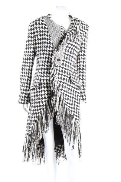 A Yohji Yamamoto hound's tooth checked coat,: A Yohji Yamamoto hound's tooth checked coat, Autumn-Winter, 2003-4. labelled, edged with fringes; together with a Commes Des Garcons black nylon dress, Autumn-Winter, 1997-8, of black open-weave wool