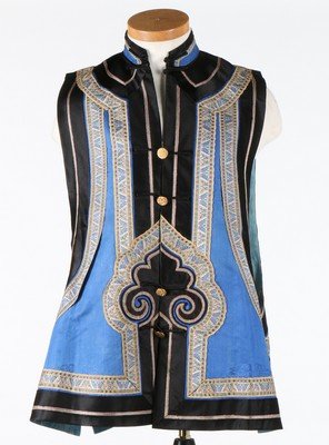 A blue silk waistcoat (xiapei), circa 1900. edged in: A blue silk waistcoat (xiapei), circa 1900. edged in black satin and ribbons woven with butterflies, gilt brass willow-pattern buttons