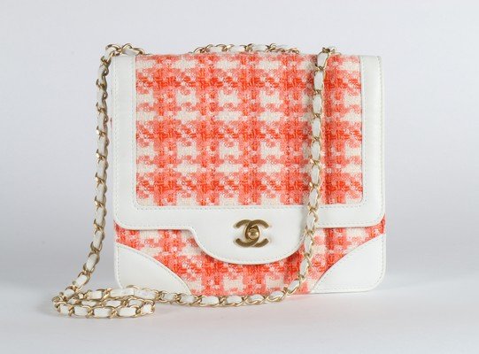 A matching Chanel orange and white tweed handbag, 2001,: A matching Chanel orange and white tweed handbag, 2001, stamped to interior, edged and lined in white leather, double chain handle, 23cm, 9in