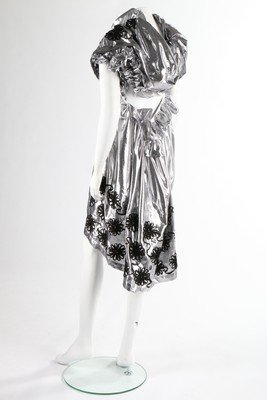 A Tao Kurihara for Comme des Garcons silver lurex: A Tao Kurihara for Comme des Garcons silver lurex dress, Autumn-Winter, 2008, labelled, the de-constructed metallic dress adorned with black soutache ribbon flowerheads, asymmetric sleeves edged with