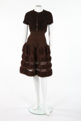 An Azzedine Alaia brown knitted silk cocktail dress,: An Azzedine Alaia brown knitted silk cocktail dress, circa 2011, labelled and size XS, the skirt of layered silk lace interspersed with slotted ribbons, bust approx 81cm, 32in; and a tufted brown raff