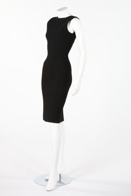 An Azzedine Alaia black silk/viscose stretch-knit: An Azzedine Alaia black silk/viscose stretch-knit dress, circa 2008, labelled and size 38, bust 81cm, 32in; together with an Anote beige wrap-around tunic with large pockets, bust approx 97cm, 38in ; 
