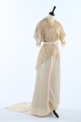 A tapelace appliqued and ivory silk bridal gown circa: A tapelace appliqued and ivory silk bridal gown circa 1914, bust approx 81cm, 32in; together with a silk damask bodice c.1900, two Edwardian silk skirts, one trimmed with illustration Duchesse, and a 