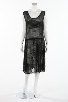 A black beaded chiffon flapper dress, circa 1928,: A black beaded chiffon flapper dress, circa 1928, adorned with bugle beaded birds in flight and cloud scrolls, bust 97cm, 38in; together with a poor condition ivory tulle gown, early 1920s with gold s