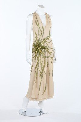 A Valentino boutique ivory crepe evening gown with: A Valentino boutique ivory crepe evening gown with sequined, beaded and ribbon bow decorations, circa 2000, labelled and size 8; together with a Valentino black organza halter-neck gown, also size 8, 