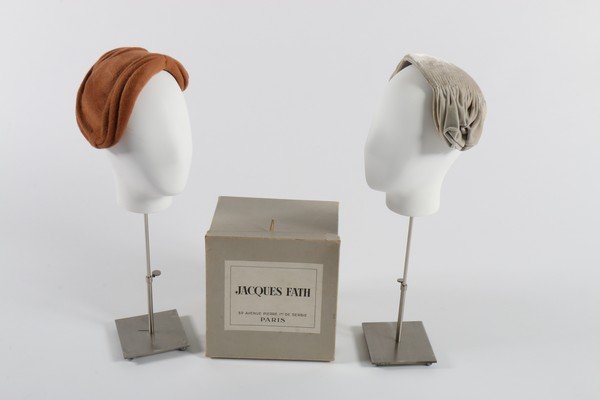 Two Jacques Fath toques, 1950s, Paris labelled, one of: Two Jacques Fath toques, 1950s, Paris labelled, one of pleated grey silk, the other of cinnamon mohair, in Fath box (3)