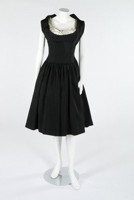 A Christian Dior London black spotted tulle dress,: A Christian Dior London black spotted tulle dress, circa 1960, labelled, edged in black velvet; together with a Ladycourt of London black silk dress, mid 1950s, busts 86cm, 34in, waists 61cm, 24in (2)
