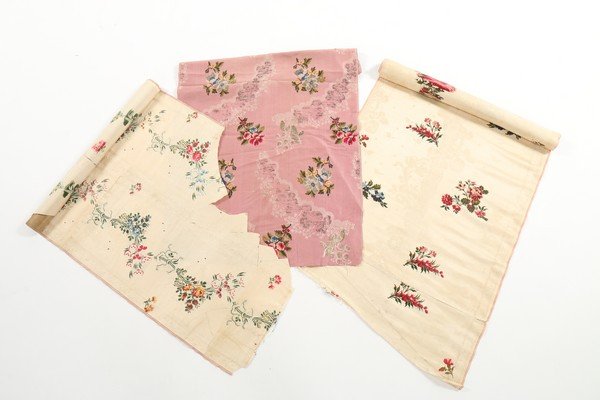 A group of mainly Spitalfields brocades, dress: A group of mainly Spitalfields brocades, dress trimmings and fragments, 1740-60, including an ivory damask length brocaded with floral sprays, approx 100 by 50cm; larger but poor condition skirt lengt