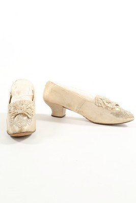 A group of ivory dance/bridal shoes, 1830-1880,: A group of ivory dance/bridal shoes, 1830-1880, comprising: two pairs of satin pumps 1830-40; white kid boots with elasticated sides c.1855 with large rosettes; a beaded pair c.1880 with shaped heel (