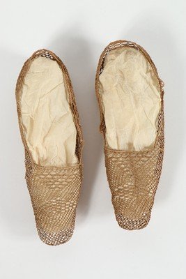A pair of woven vegetable fibre summer shoes, probably: A pair of woven vegetable fibre summer shoes, probably French colonial, circa 1830, together with a red leather Regency purse with plated mounts, 8cm, 3in long, and a pair of knitted gloves (5)