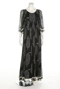 A Thea Porter printed black chiffon smock dress, 1969,: A Thea Porter printed black chiffon smock dress, 1969, labelled 'Thea Porter London' and size 10, the fabric designed by Michael Szell, with foliate Paisley style repeats, edged in white velvet ribbon