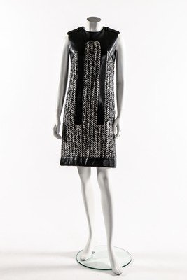 A Pierre Cardin leather and herring bone weave tweed: A Pierre Cardin leather and herring bone weave tweed mini-dress, 1968, un-labelled, of soft black leather with button detailing to shoulders, bust 86cm 34in; together with a Pierre Cardin black patent