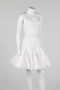 An Azzedine Alaïa white fagotted cotton dress, circa: An Azzedine Alaïa white fagotted cotton dress, circa 2011, labelled, formed from graduated cotton gores which widen into flounces at the hem, bust 81cm, 32in; and a cropped cotton blouse with drawstr