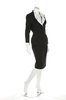 Two Thierry Mugler suits, 1980s, labelled, comprising: Two Thierry Mugler suits, 1980s, labelled, comprising beige 'safari'-style jacket with four pockets to front, black skirt; and black wool jersey jacket with white lapels and cuffs, slim skirt, chests