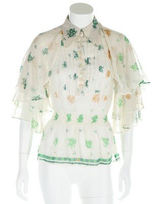 An Ossie Clark/Celia Birtwell printed muslin blouse,: An Ossie Clark/Celia Birtwell printed muslin blouse, circa 1970, black and white printed satin label, with shirred waist and flounced sleeves, bust approx 101cm, 40in; together with an ivory moss crep