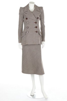 A Biba brown and white hound's tooth checked skirt: A Biba brown and white hound's tooth checked skirt suit, 1974, printed satin label, double-breasted with large chunky buttons; together with a sage green jumbo-needlecord maxi coat, 73-4; and a tan ch