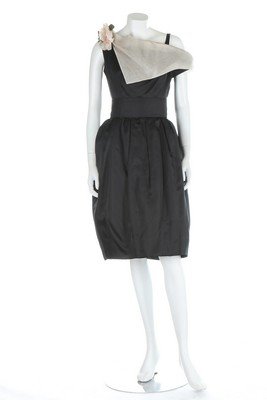 A Christian Dior London black organza cocktail dress,: A Christian Dior London black organza cocktail dress, 1960s, labelled and numbered 23189, with wide, white collar, pink silk corsage and matching black belt, bust 86cm, 34in, waist 66cm, 26in (2)
