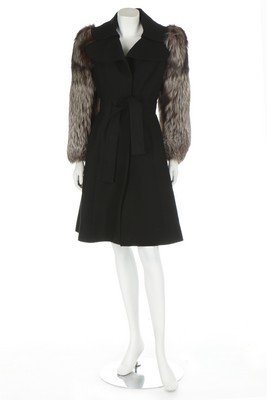 A black wool coat with fox fur sleeves, late 1960s,: A black wool coat with fox fur sleeves, late 1960s, un-labelled, with slotted tie belt; together with a wine-coloured wool coat with dyed red fox fur trim and belt with futuristic metal buckle, un-lab