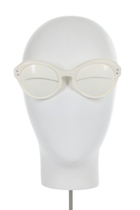 A pair of Courrèges white plastic 'eskimo' sunglasses,: A pair of Courrèges white plastic 'eskimo' sunglasses, 1964, signed along the arms, the solid lenses with horizontal slits, 15cm, 6in long